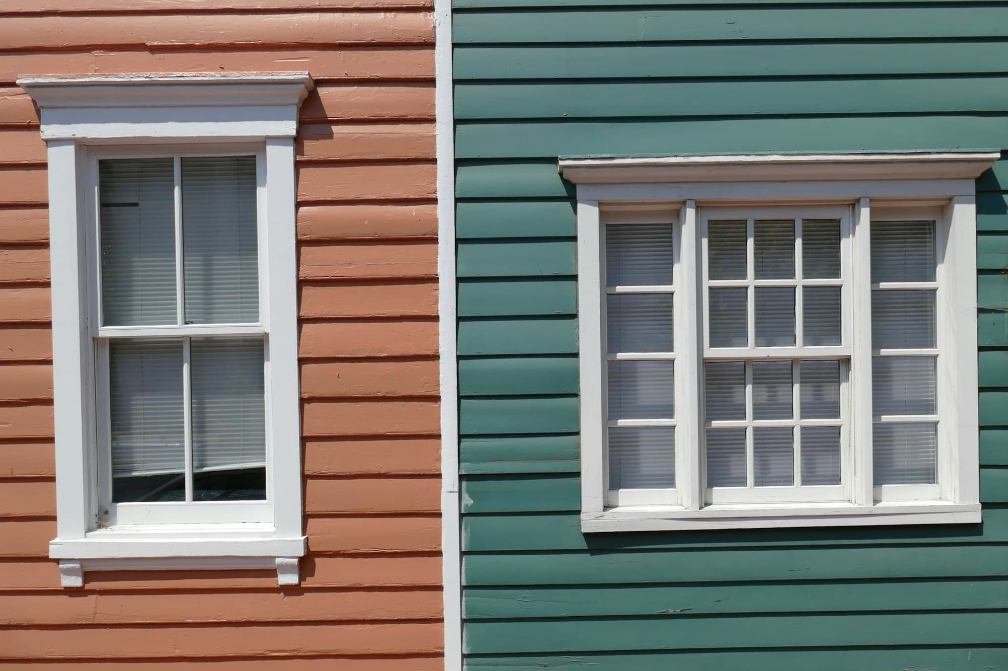 Painted wood siding with white-trimmed windows